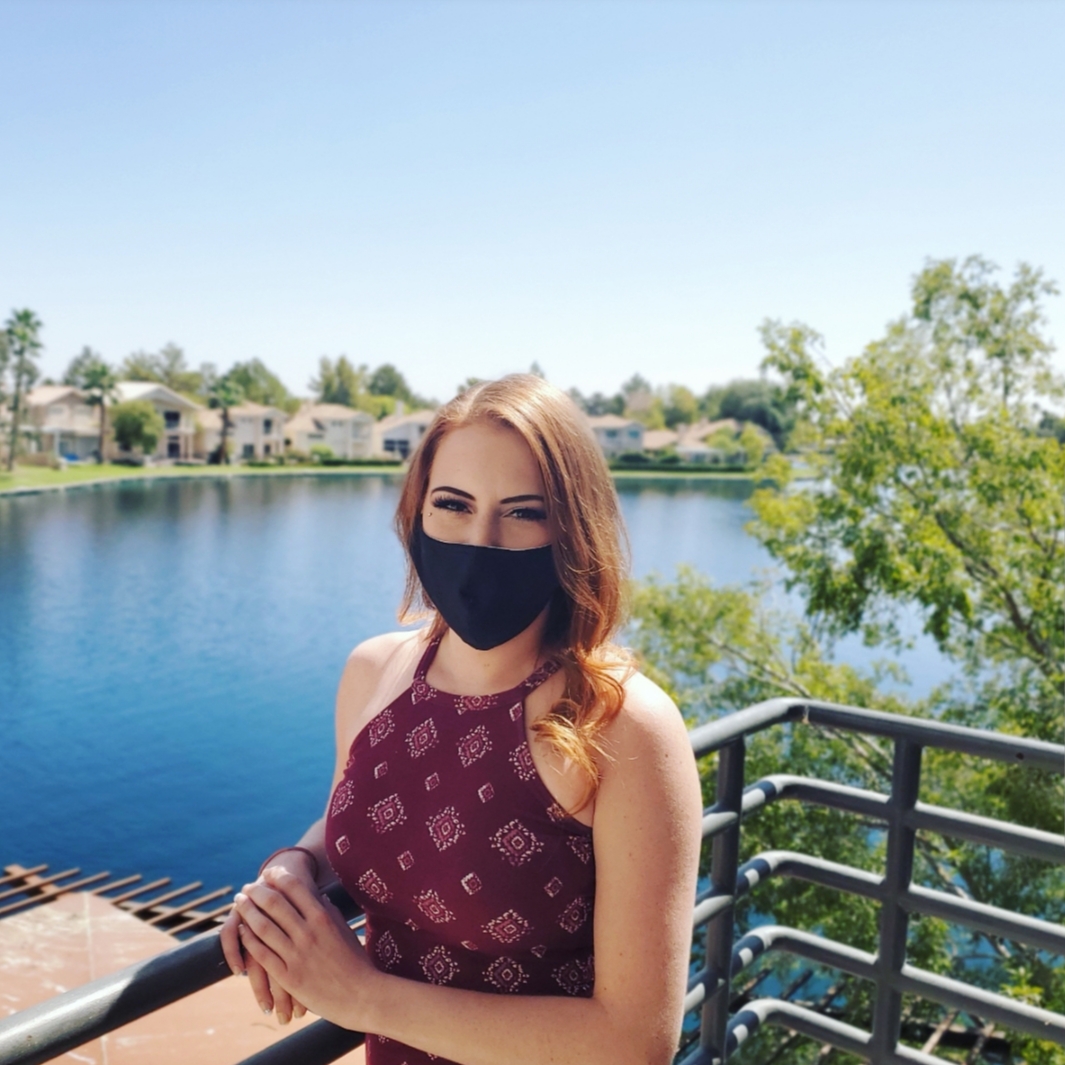 Alexa Melby with mask on, at The Salon at Lakeside with Lake in background