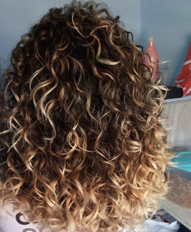 Image of backside of clients curly hair at The Salon at Lakeside